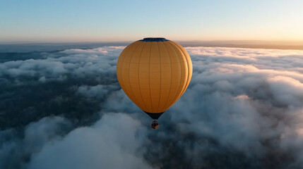 Obraz premium Hot air balloon floats above the clouds during sunrise, creating a breathtaking aerial view of the landscape