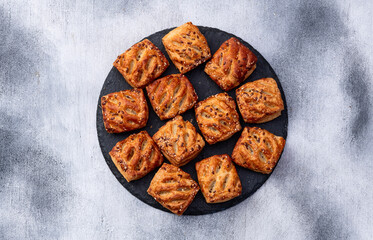 Flaky Pastries with Sesame Seeds on Slate