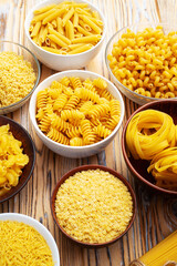 Assorted Uncooked Pasta in Bowls on Wooden Table