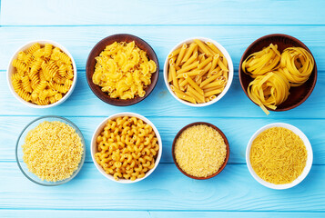 Assorted Uncooked Pasta in Bowls on Wooden Table