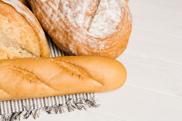 Homemade natural breads. Different kinds of fresh bread as background, perspective view with copy space