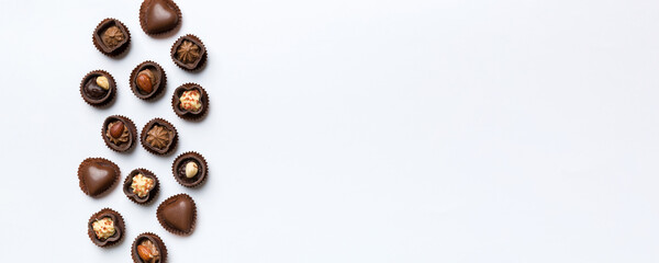 Different kinds of chocolates on colored table close-up. Top View and Flat Lay with copy space