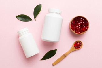 different drugs and health supplement pills with medicine bottle health care and medical top view. Vitamin tablets. Bottle with colored pills on table background. Multivitamins