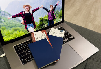 Fototapeta premium Airplane with passport on a laptop. Buy your flight ticket online
