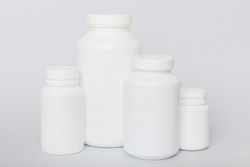 supplement pills with medicine bottle health care and medical top view. Vitamin tablets. Top view mockup bottle for pills and vitamins with green leaves, natural organic bio supplement, copy space