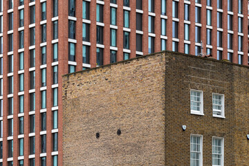 This image depicts the textured walls of a contemporary building, reflecting modern design principles that blend the old with the new in an urban environment.