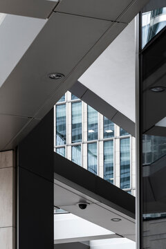 This image captures geometric views of modern architecture, creating an interplay of light and shadows that reflect the contemporary design ethos of urban spaces.