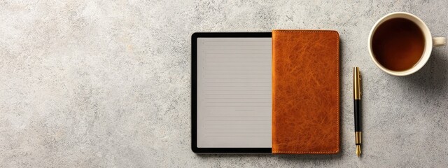 Fototapeta premium Elegant Workspace Setup Featuring Tablet, Notebook, Coffee Cup, and Gold Pen on Textured Background