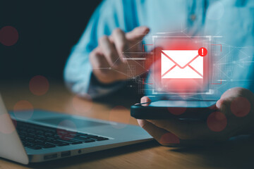 Business man using smartphone and computer that show warning sign after got attack phishing email by malware from hacker that commit cyber crime or software crash to cause an error.