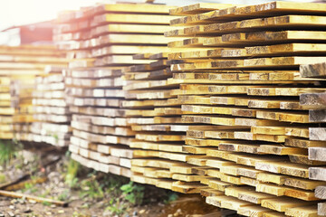 Stack of fresh pine boards in a sawmill warehouse. Harvesting, sale of lumber for construction
