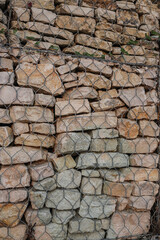 Stacked stones secured with wire mesh form a unique texture in Albania's landscape