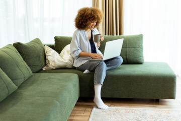 Enjoying a quiet morning with coffee and work in a cozy living room on a sunny day