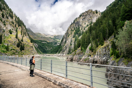 Switzerland, Valais, woman on a hiking trip from Blatten to Riederalm on a dam wall