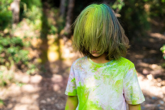 Boy full of colorful powder paint, celebrating Holi, Festival of Colors