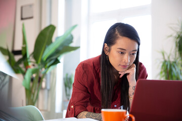 Woman using laptop in office