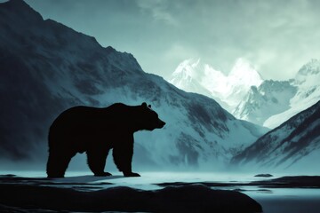 Silhouette of a brown bear walking in a beautiful snowy mountain landscape, creating a powerful image of wildlife and nature