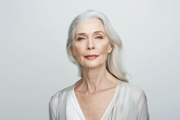 Fototapeta premium Graceful Aging: Beautiful Senior Woman with Natural Hair and Subtle Makeup