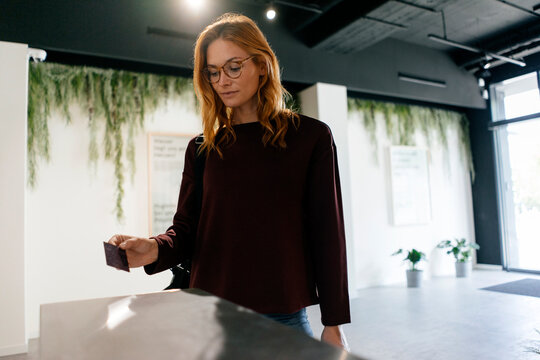 Young woman entering spa area with chip card