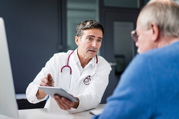 Doctor showing tablet to patient in medical practice