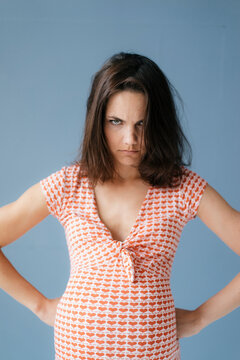 Woman pretending to be pregnant, looking angry