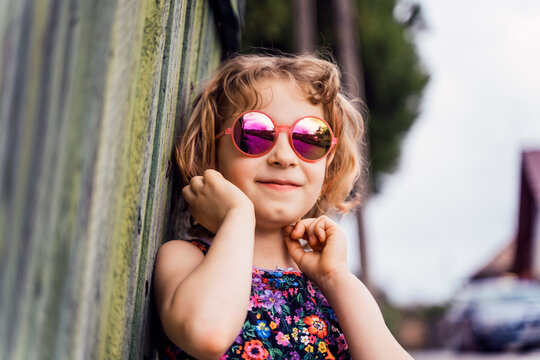 Portrait of smiling little girl wearing sunglasses