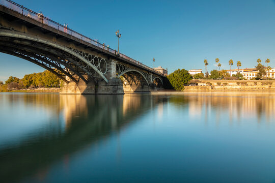 Long exposure of Puente de Triana on Guadalquivir River, Seville, Spain