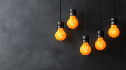 Five orange light bulbs hang from black cables, adding warmth and charm to a dark interior space