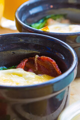 Small bowl of baked cheese and tomato