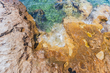 Crystal Clear Waters and Rocky Shoreline in Greece, Sunny Summer Day