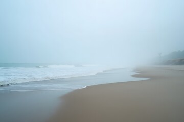 A foggy beach with soft waves and muted tones, creating a mystical atmosphere.