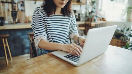 Young asian business woman working on laptop computer in coffee shop freelance at work.