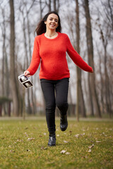 Pregnant woman running with ultrasound outdoors