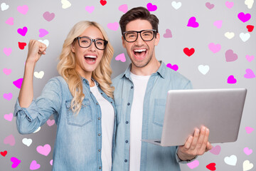 Photo of two funny people teammates guy hold pc rejoice wear casual jeans outfit isolated grey color background