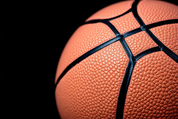 Close-Up of a Textured Orange Basketball on a Black Background