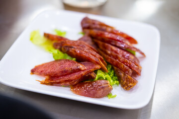 Slice of Chinese and Thai style sausages on with dish