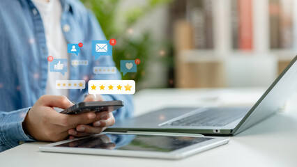Customer review good rating concept, A man using a smartphone to give a 5-star customer review....