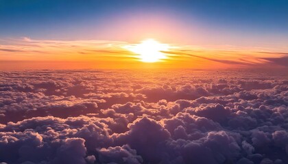 flight over the clouds. view of the big and beautiful cumulus clouds on suset. crimson sky from the sun's rays