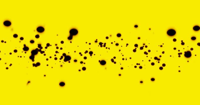 Black particles float on an intense yellow background. 4k loop animation. The dots are of different sizes and are placed in various positions. The scene conveys a sense of nuclear, radioactive or bioh