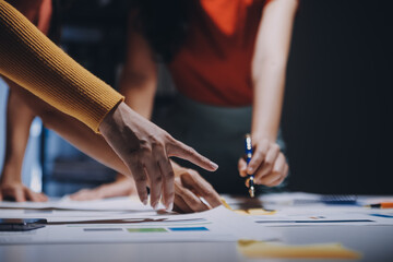 Business people working late at laptop in highrise office