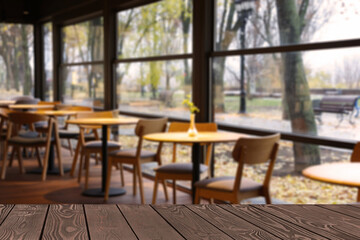 Empty wooden table in restaurant, space for design