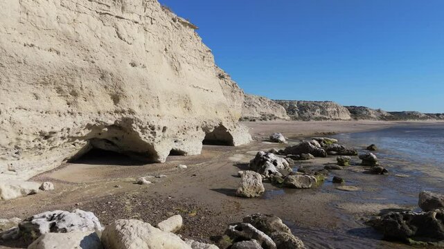 Descending flight over the caves in El Ca&ntilde;adon de las Ostras, on the coast of the Argentinian Sea, Rio Negro, Patagonia, Argentina.
