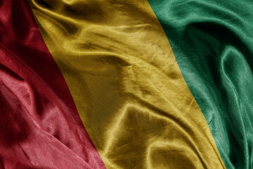 shine waving colourful realistic national flag of guinea . macro shot