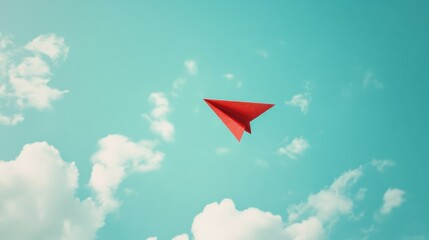 Red Paper Airplane Soaring Through Turquoise Sky with Fluffy White Clouds.