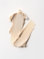 Closeup of beige hair styling wax or clay smear with a matte finish