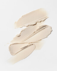 Closeup of beige hair styling wax or clay smear with a matte finish