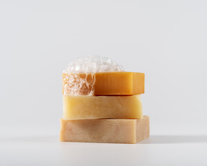 Crafted soap bars with foamy bubbles on a white background