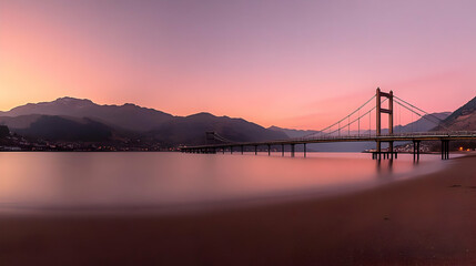 Long Exposure of a Bridge over Calm Water at Sunset with Mountains in the Background