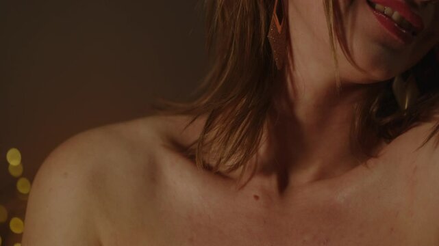 Tilt up of the beautiful body of an enticing woman smiling in slow motion