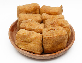 Tofu is a food prepared by coagulating soy milk and then pressing the resulting curds into solid white blocks of varying softness: silken, soft, firm.