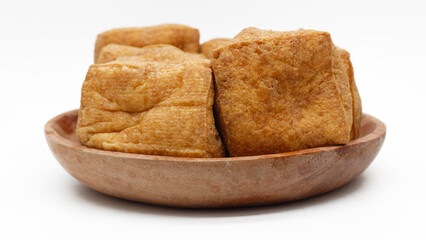 Tofu is a food prepared by coagulating soy milk and then pressing the resulting curds into solid white blocks of varying softness: silken, soft, firm.